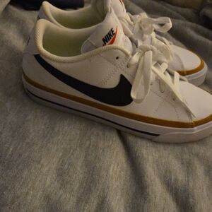 Nike White and Black Sneakers with Gold Stripe